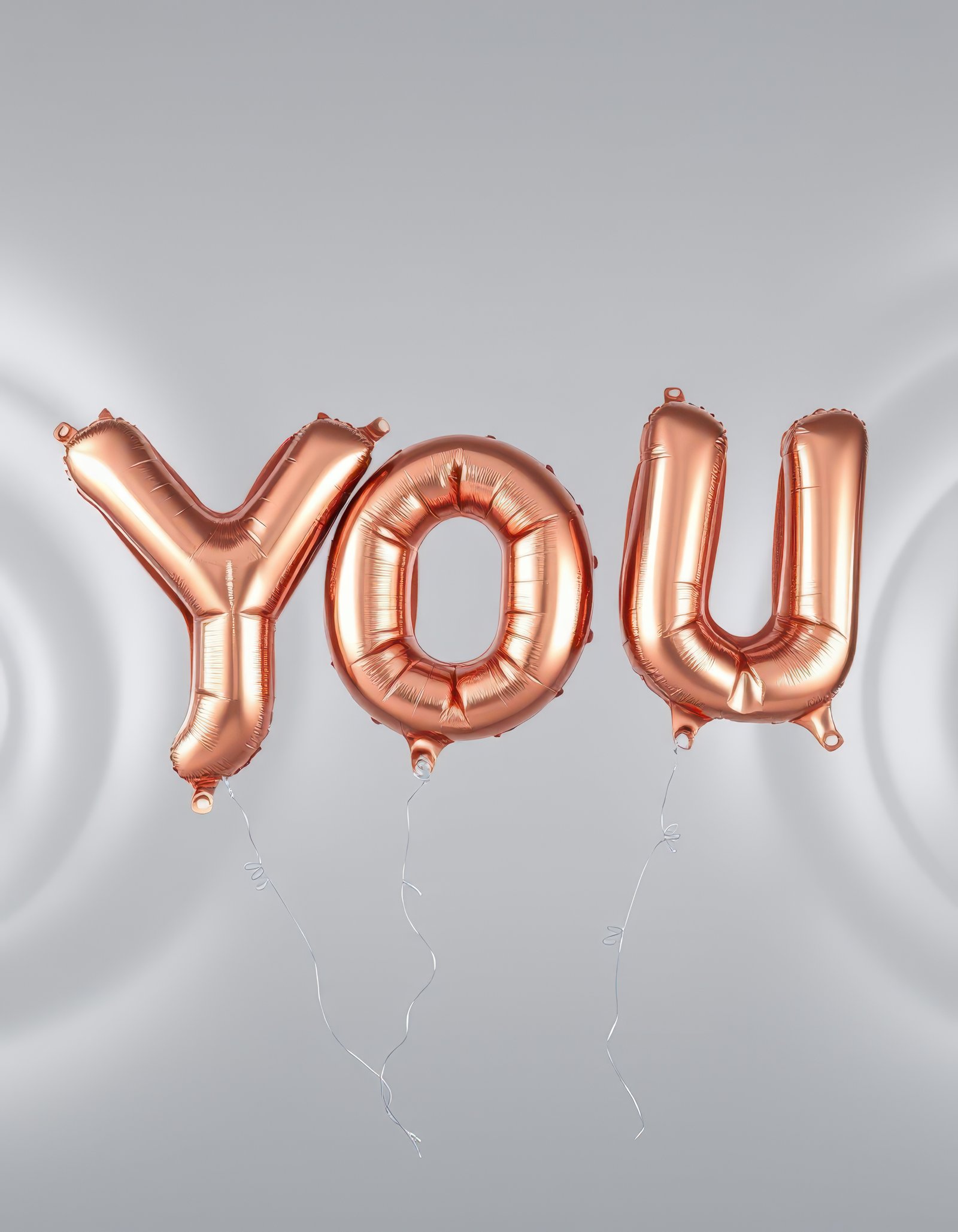 Celebrate special moments with elegant rose gold balloons spelling you in a festive setting
